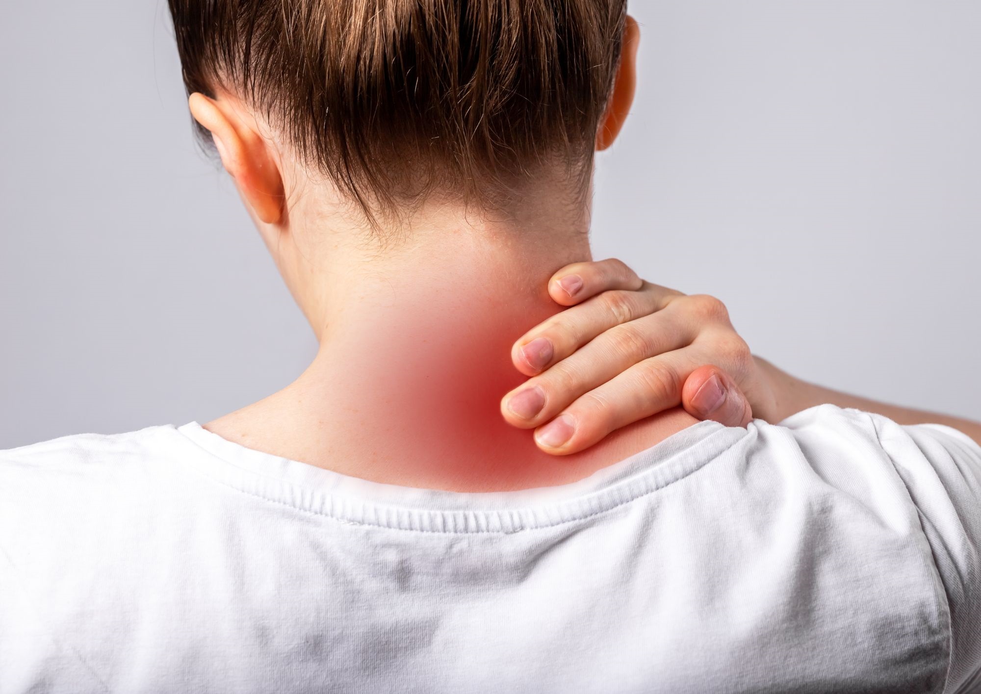 A woman suffering from neck pain.